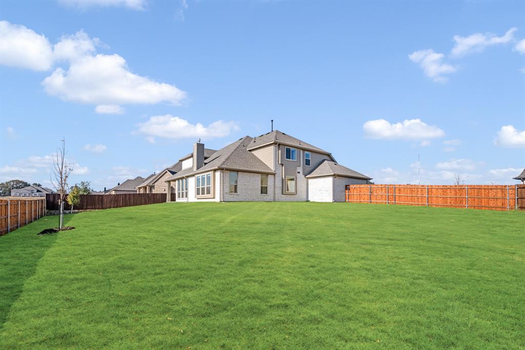 2401 Rileigh Lane Mansfield, TX 76063 - Photo 39 of 40 a view of a big house with a big yard and a large tree