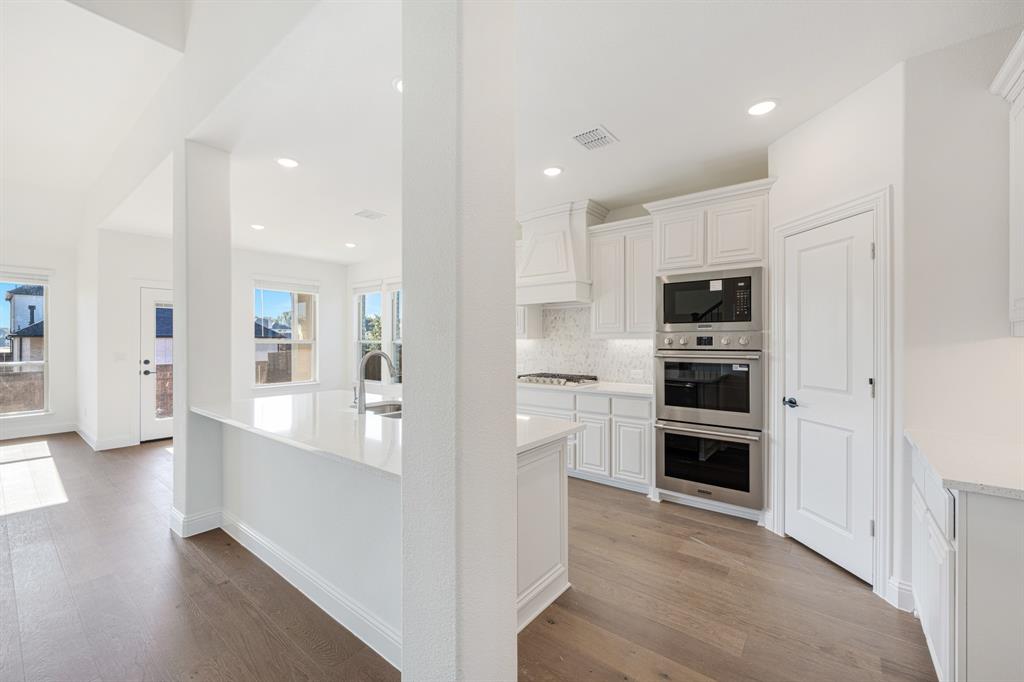 2401 Rileigh Lane Mansfield, TX 76063 - Photo 9 of 40 a large kitchen with cabinets and stainless steel appliances