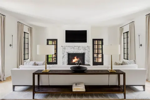 a living room with a fireplace and a flat screen tv
