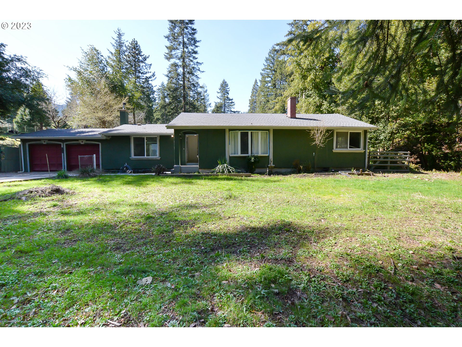 207 Snowberry Road Roseburg, OR 97471 - Photo 1 of 31 a view of a house with a yard and trees