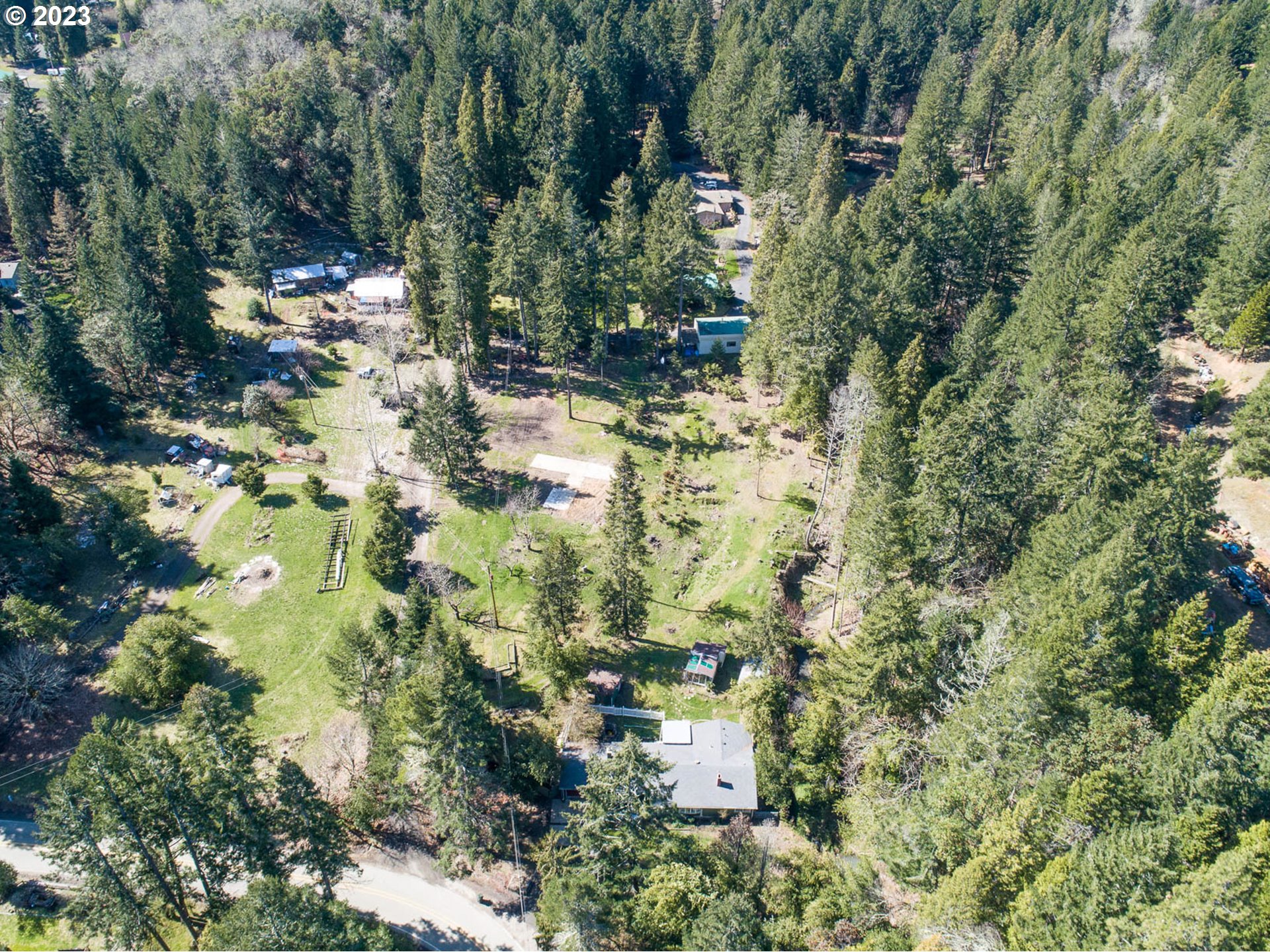 207 Snowberry Road Roseburg, OR 97471 - Photo 18 of 31 a view of a yard with large trees