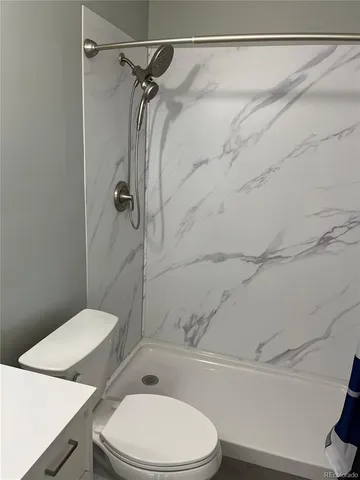a white toilet and tub next to a bathroom sink