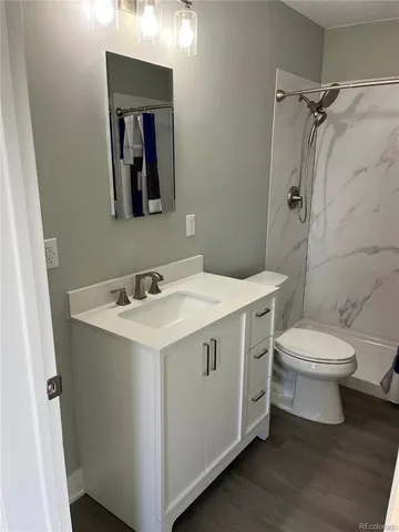 a view of bathroom with a toilet sink and mirror