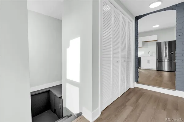 a view of a hallway with wooden shelves