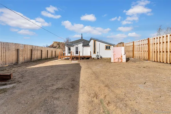 a view of a house with wooden fence