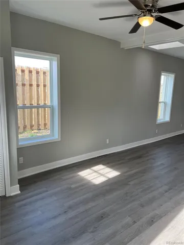 a view of an entryway with wooden floor and door