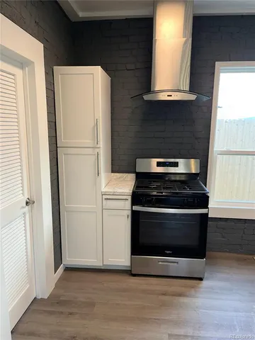 a kitchen with a stove and a refrigerator