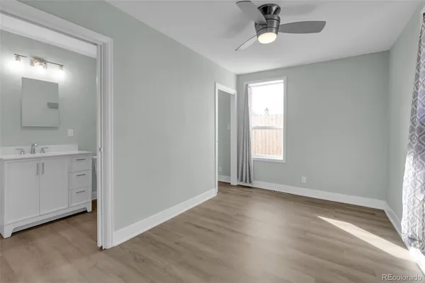 a view of entryway with kitchen and hardwood floor