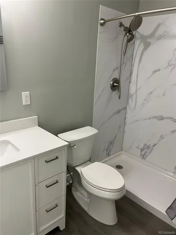 a bathroom with a toilet and a shower