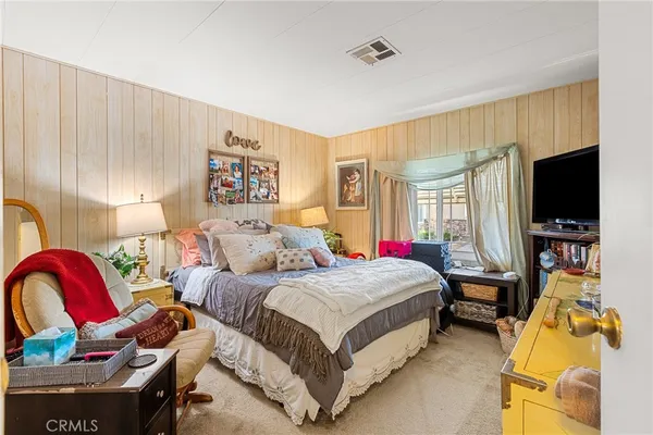 a bedroom with a bed and a couch