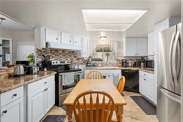 a kitchen with a refrigerator a stove a sink and a refrigerator