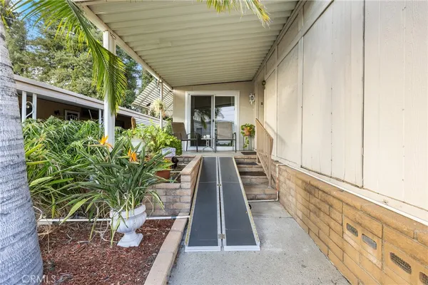 a house with potted plants in front of it