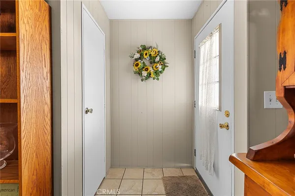 a dining room with furniture a chandelier and window