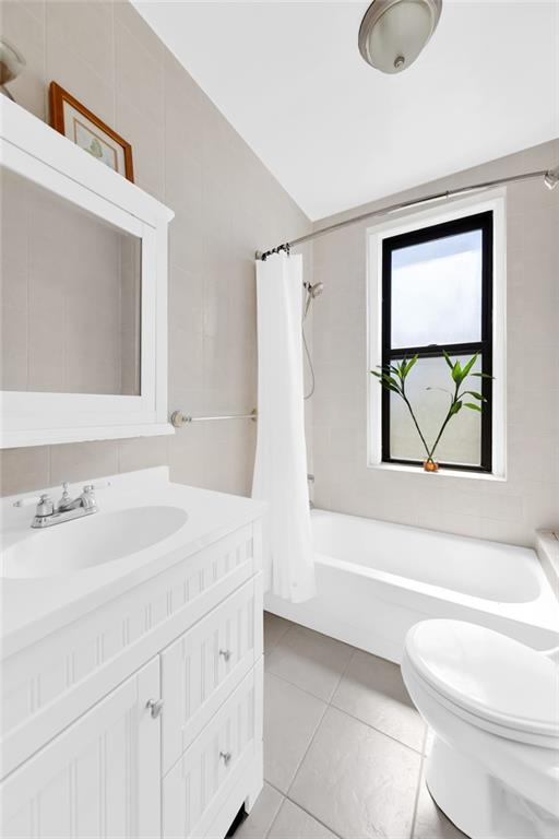 255 79th Street, Unit D8 Brooklyn, NY 11209 - Photo 4 of 8 a bathroom with a sink a toilet and a bathtub
