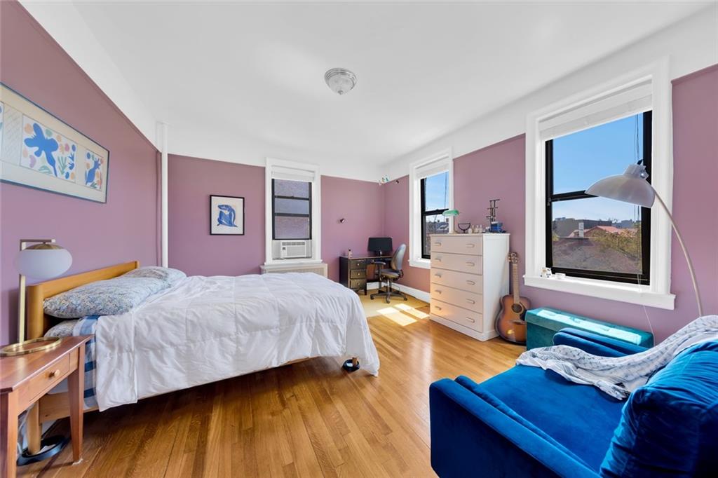 255 79th Street, Unit D8 Brooklyn, NY 11209 - Photo 5 of 8 a bedroom with a bed and wooden floor