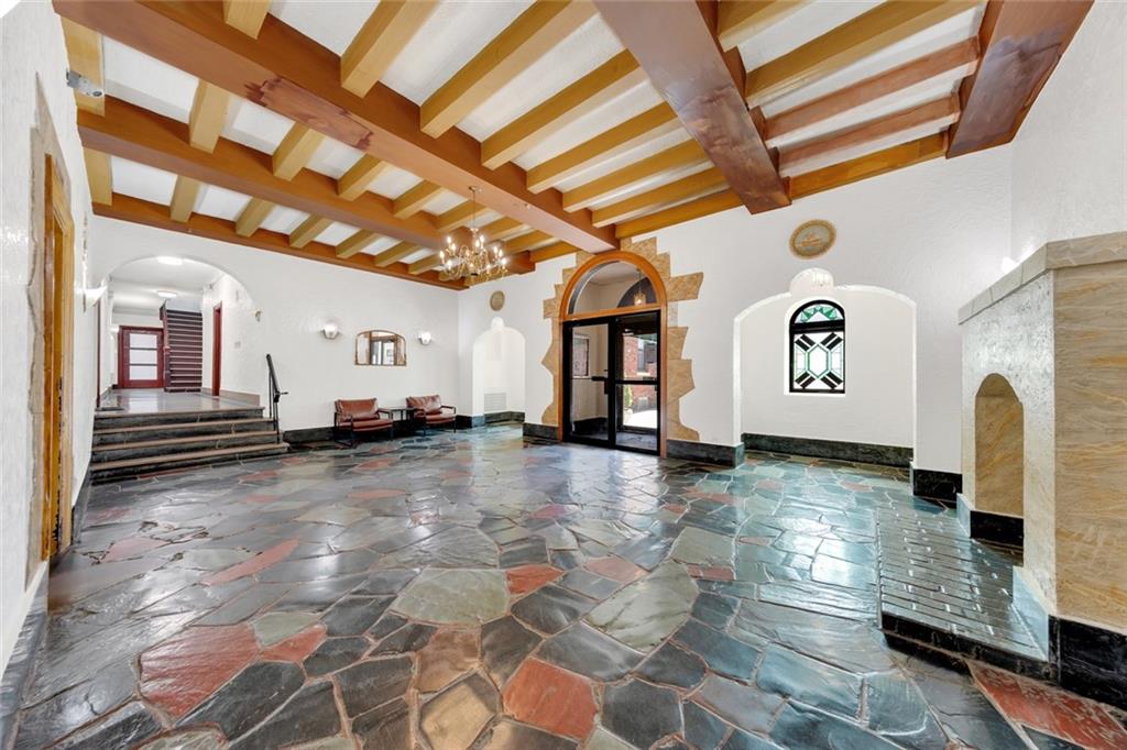 255 79th Street, Unit D8 Brooklyn, NY 11209 - Photo 6 of 8 a view of a hallway with entryway chandelier and front door