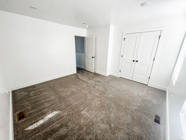 522 West 2000 South Vernal, UT 84078 - Photo 18 of 18 Unfurnished bedroom featuring dark carpet and a closet