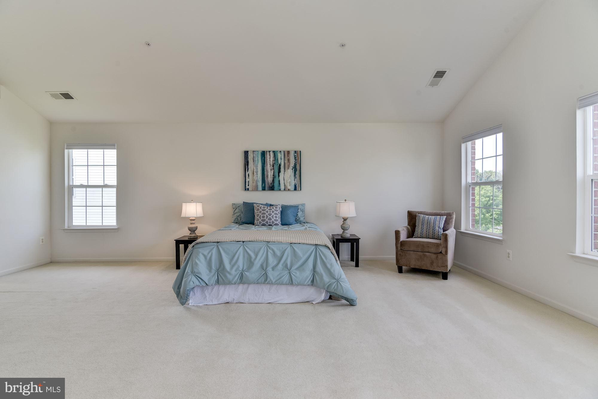 14629 Bubbling Spring Road Boyds, MD 20841 - Photo 20 of 30 a spacious bedroom with a bed and a couch