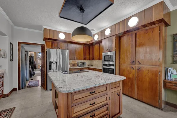 a kitchen with cabinets and stainless steel appliances