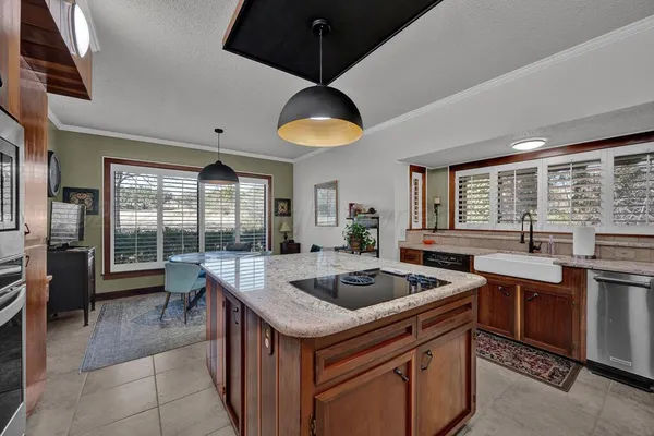 a kitchen that has a sink and a stove in it