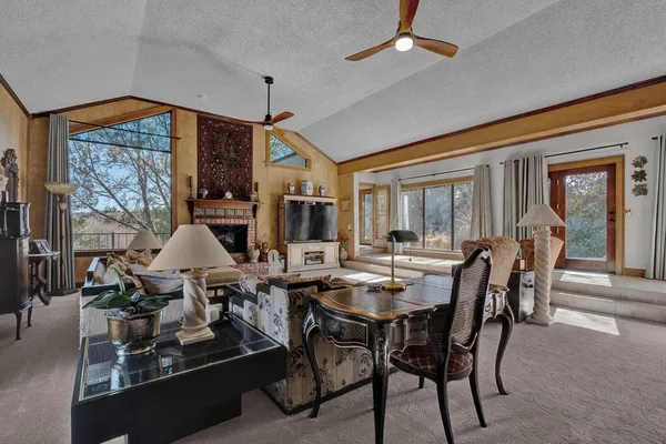 a dining room with furniture a chandelier and window