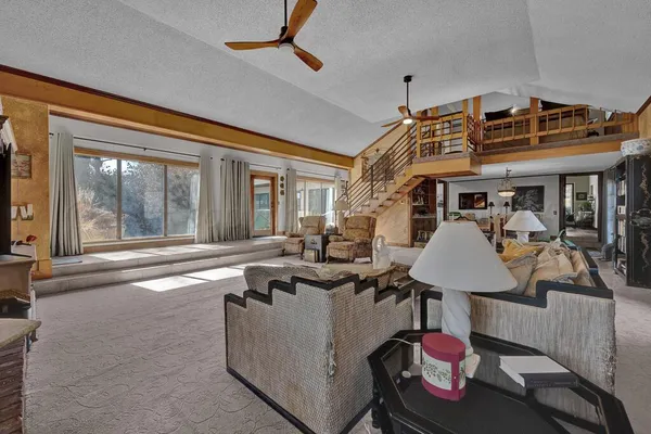 a living room with furniture a rug and a chandelier