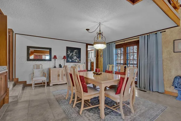 a view of a dining room with furniture and window