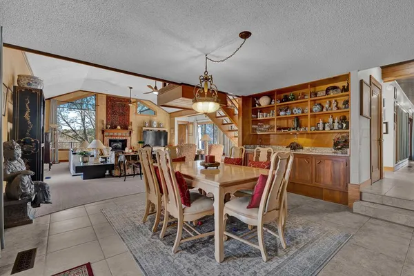 a view of a dining room with furniture and chandelier