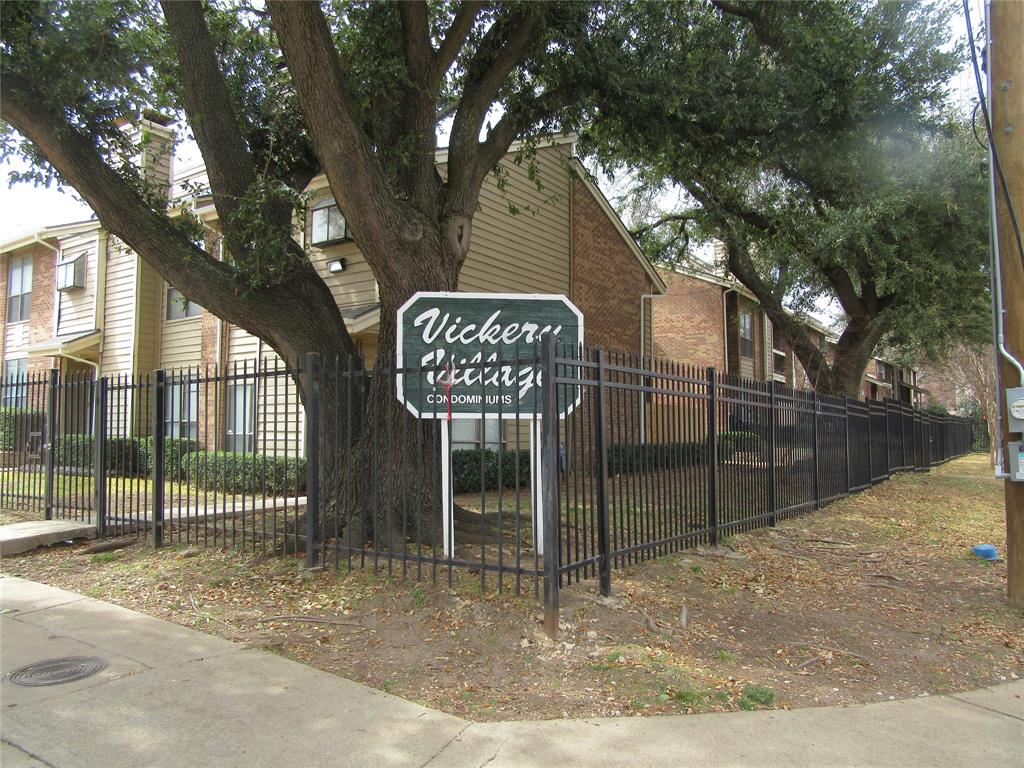 a view of a street sign under a large tree