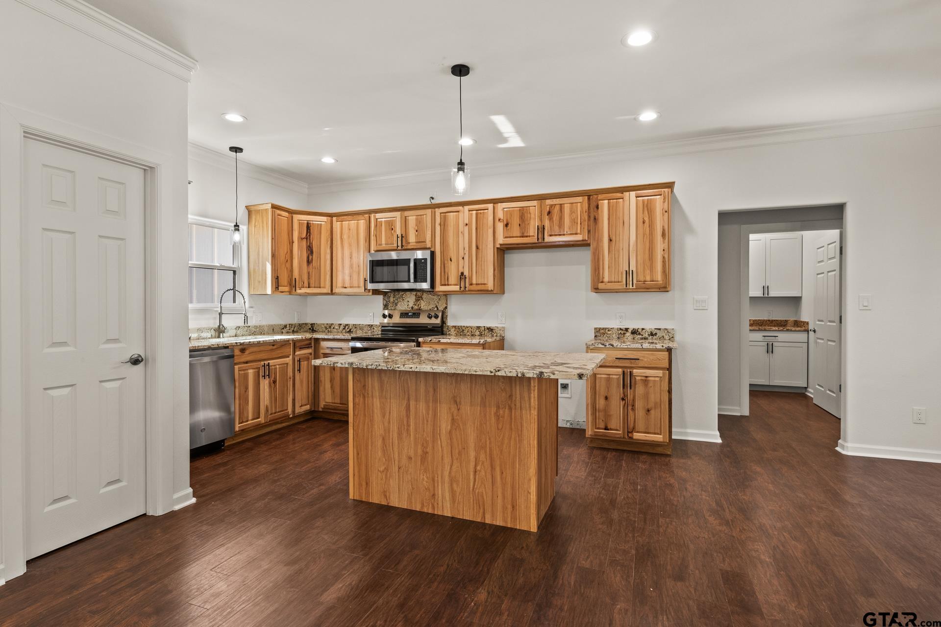 1339 Hwy 67 Mount Mount Vernon, TX 75457 - Photo 12 of 47 a kitchen with granite countertop a sink cabinets and wooden floor