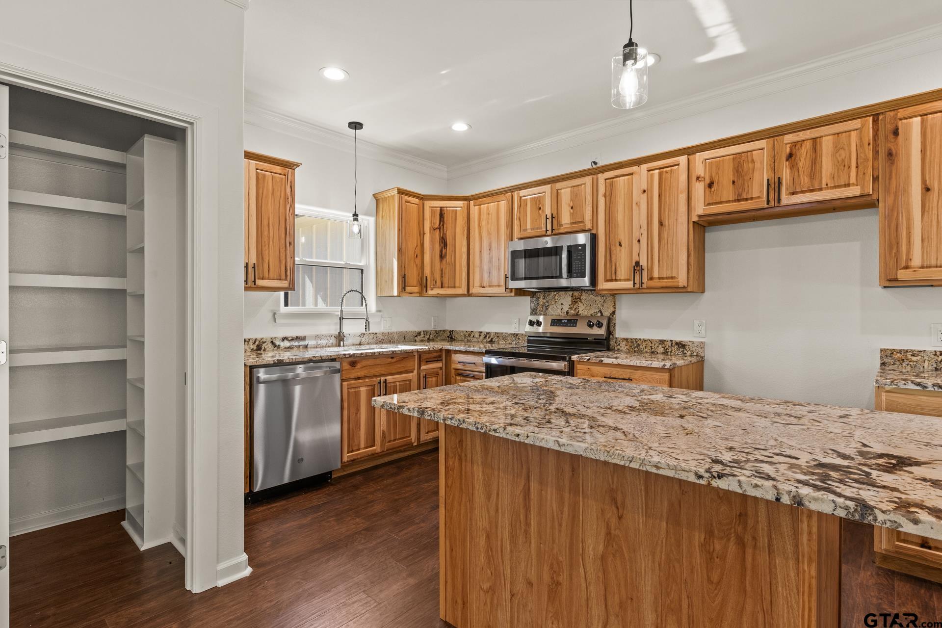 1339 Hwy 67 Mount Mount Vernon, TX 75457 - Photo 13 of 47 a kitchen with stainless steel appliances granite countertop a stove sink microwave and cabinets