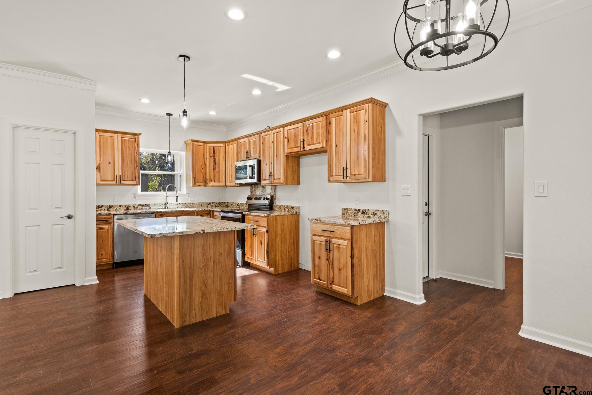 1339 Hwy 67 Mount Mount Vernon, TX 75457 - Photo 14 of 47 a kitchen with stainless steel appliances granite countertop a stove a sink dishwasher and a refrigerator with wooden floor