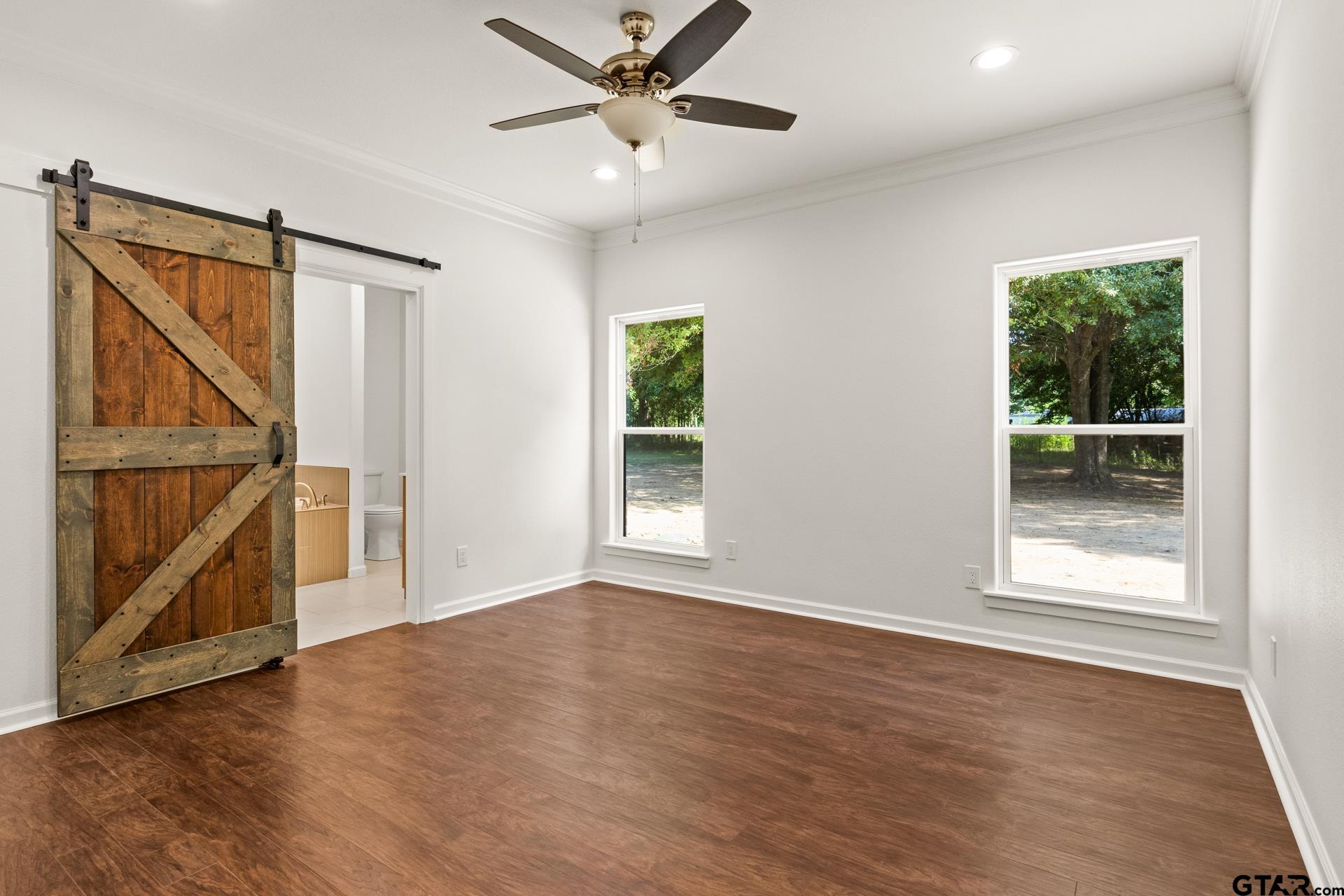 1339 Hwy 67 Mount Mount Vernon, TX 75457 - Photo 21 of 47 an empty room with wooden floor fan and windows