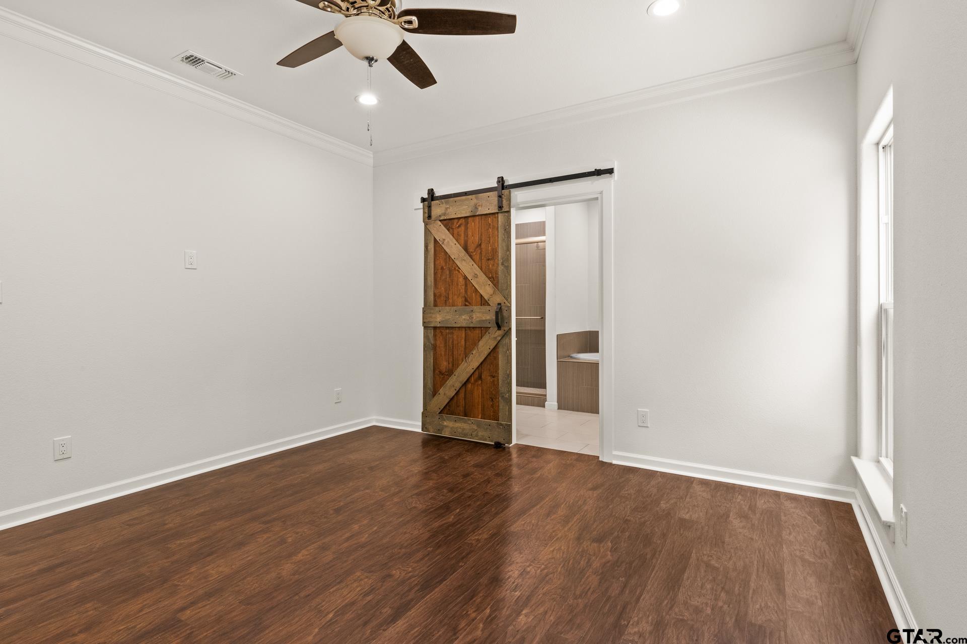 1339 Hwy 67 Mount Mount Vernon, TX 75457 - Photo 22 of 47 an empty room with wooden floor ceiling fan and window