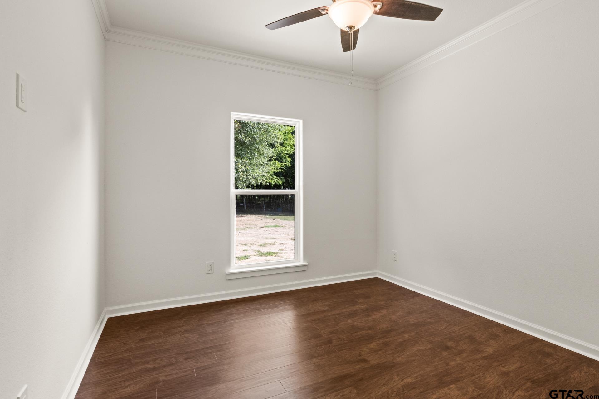1339 Hwy 67 Mount Mount Vernon, TX 75457 - Photo 27 of 47 an empty room with wooden floor chandelier fan and windows