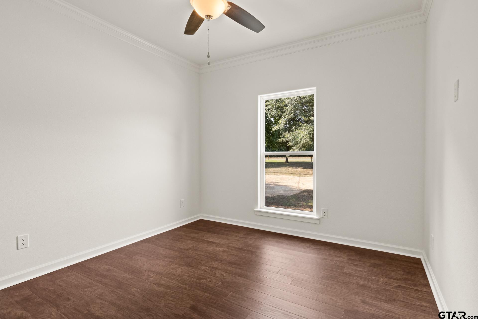 1339 Hwy 67 Mount Mount Vernon, TX 75457 - Photo 31 of 47 an empty room with wooden floor chandelier fan and windows