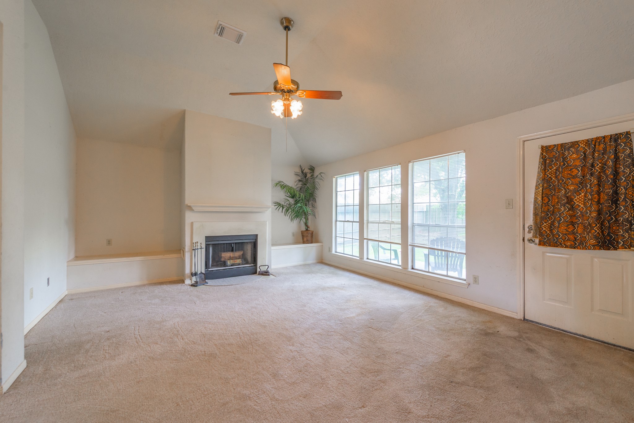 12203 Canterhurst Way Houston, TX 77065 - Photo 6 of 23 a view of an empty room with a fireplace and a window