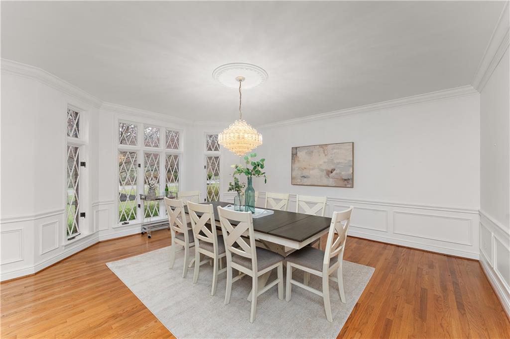 7 Meadowood Drive Pittsburgh, PA 15215 - Photo 12 of 45 a dining room with furniture a chandelier and wooden floor
