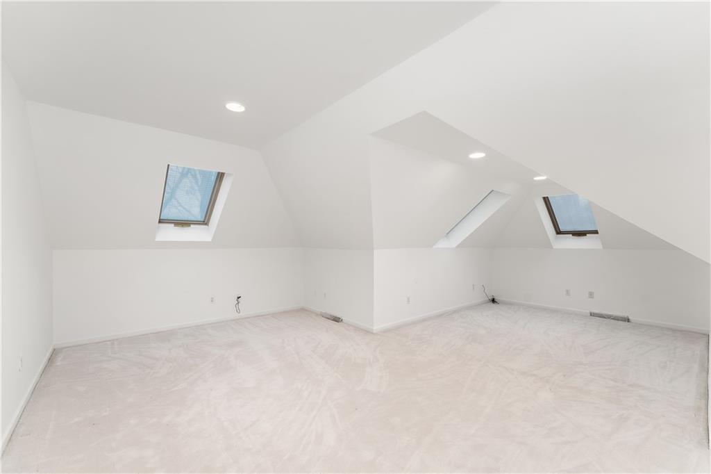 7 Meadowood Drive Pittsburgh, PA 15215 - Photo 26 of 45 an empty room with a projector and white walls