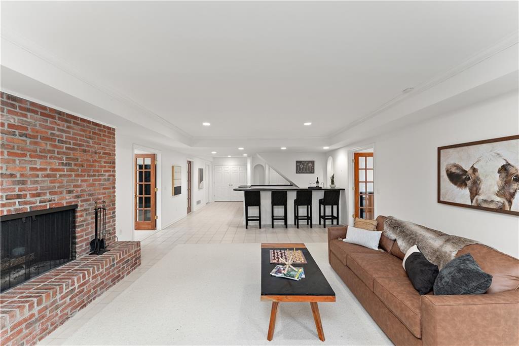 7 Meadowood Drive Pittsburgh, PA 15215 - Photo 29 of 45 a living room with furniture a fireplace and a flat screen tv