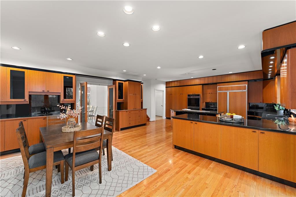 7 Meadowood Drive Pittsburgh, PA 15215 - Photo 10 of 45 a dining hall with stainless steel appliances granite countertop a couch a dining table and chairs