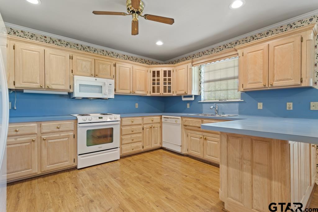 14762 County Road 3147 Tyler, TX 75706 - Photo 11 of 48 a kitchen with granite countertop white cabinets white stainless steel appliances and sink