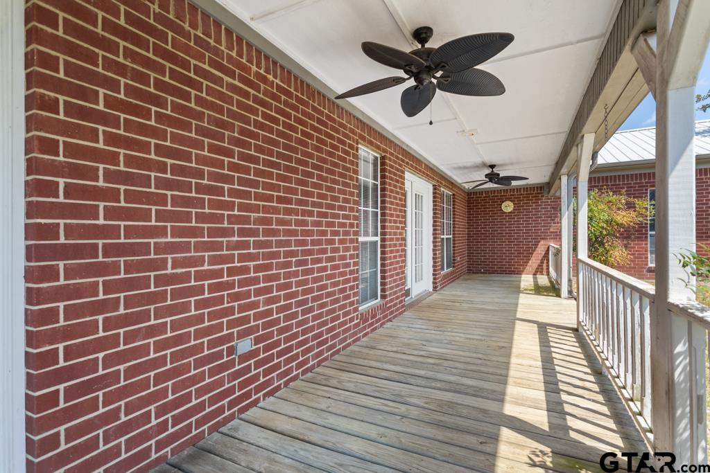 14762 County Road 3147 Tyler, TX 75706 - Photo 22 of 48 a view of a balcony with a ceiling fan