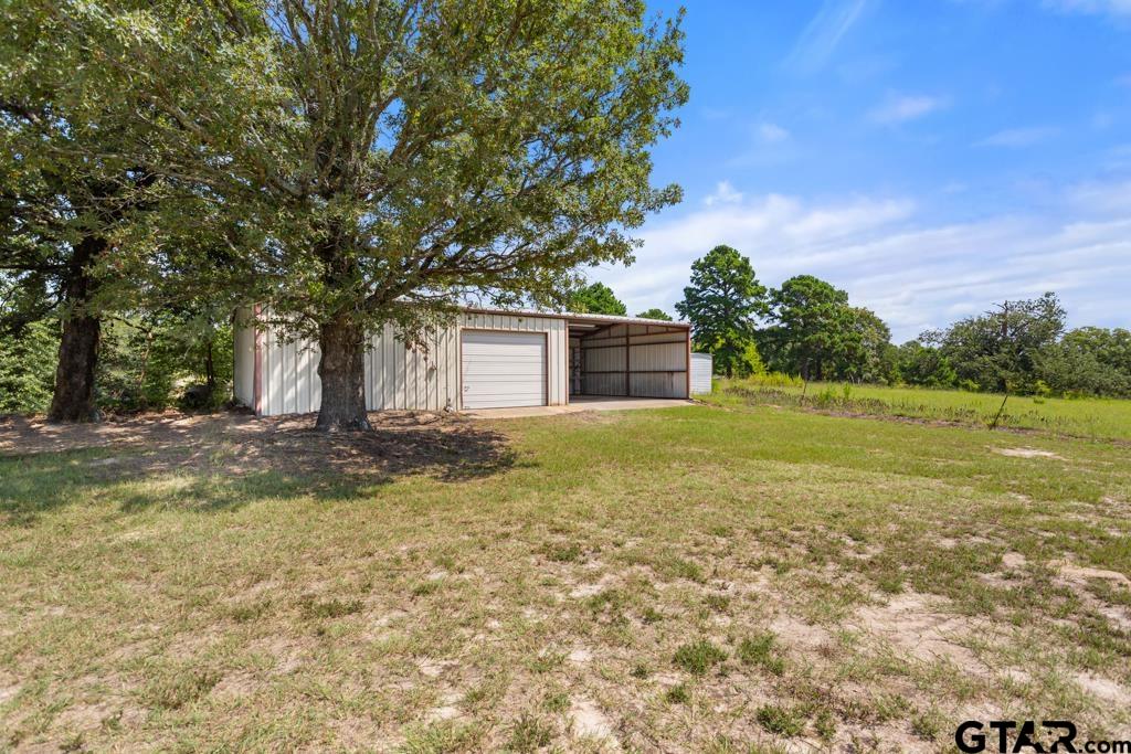 14762 County Road 3147 Tyler, TX 75706 - Photo 27 of 48 a backyard of a house with lots of green space