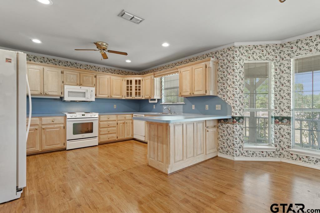 14762 County Road 3147 Tyler, TX 75706 - Photo 10 of 48 a kitchen with stainless steel appliances granite countertop a stove a sink and a microwave