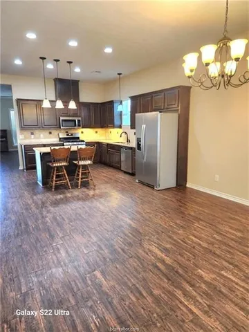 a kitchen with a table and chairs