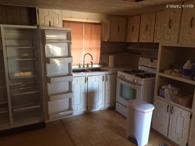 331 North Pima Benson, AZ 85602 - Photo 5 of 7 a kitchen with a refrigerator stove and cabinets