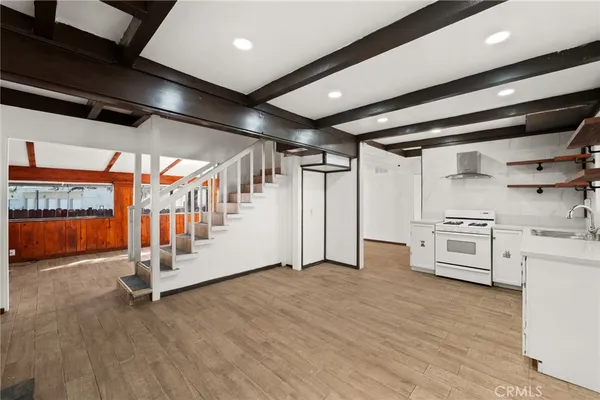 a view of an empty room with white cabinets