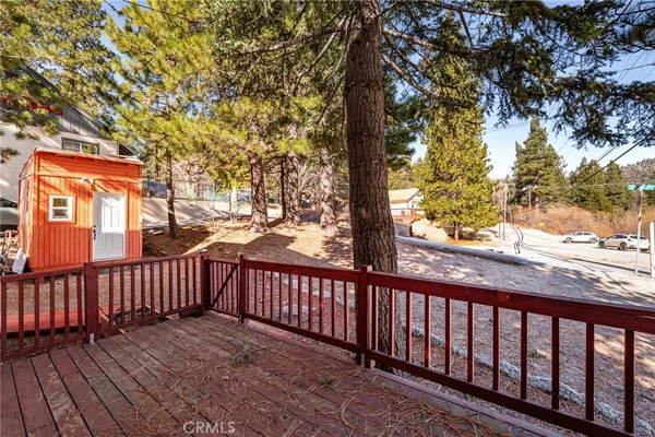 a balcony with wooden floor and fence