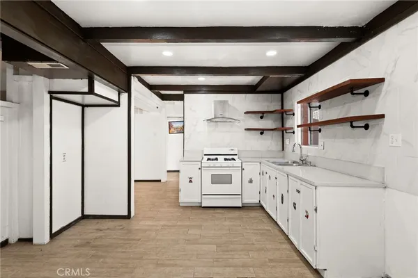 a kitchen with white cabinets and white appliances